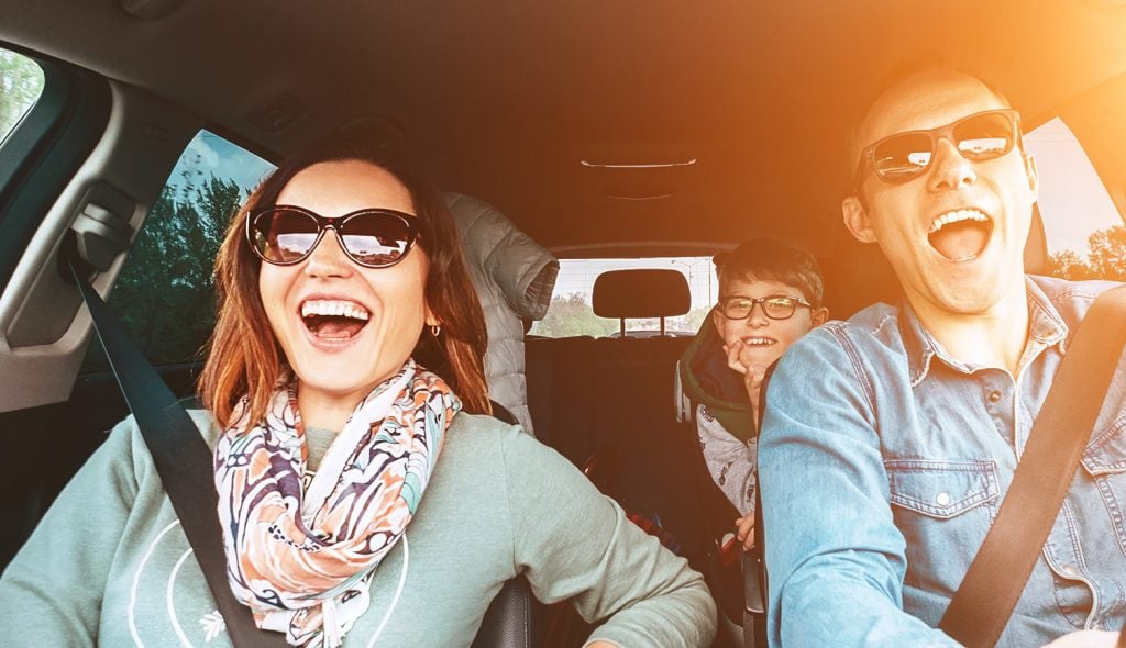 Family singing together while on a car road trip.