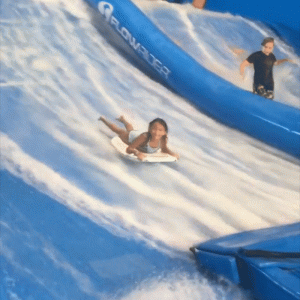 young girl on a boogie board playing on surfing water slide at Great Wolf Lodge
