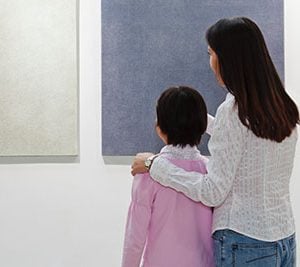 Mom and daughter looking at painting.