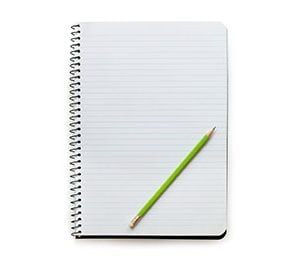 green pencil on notebook