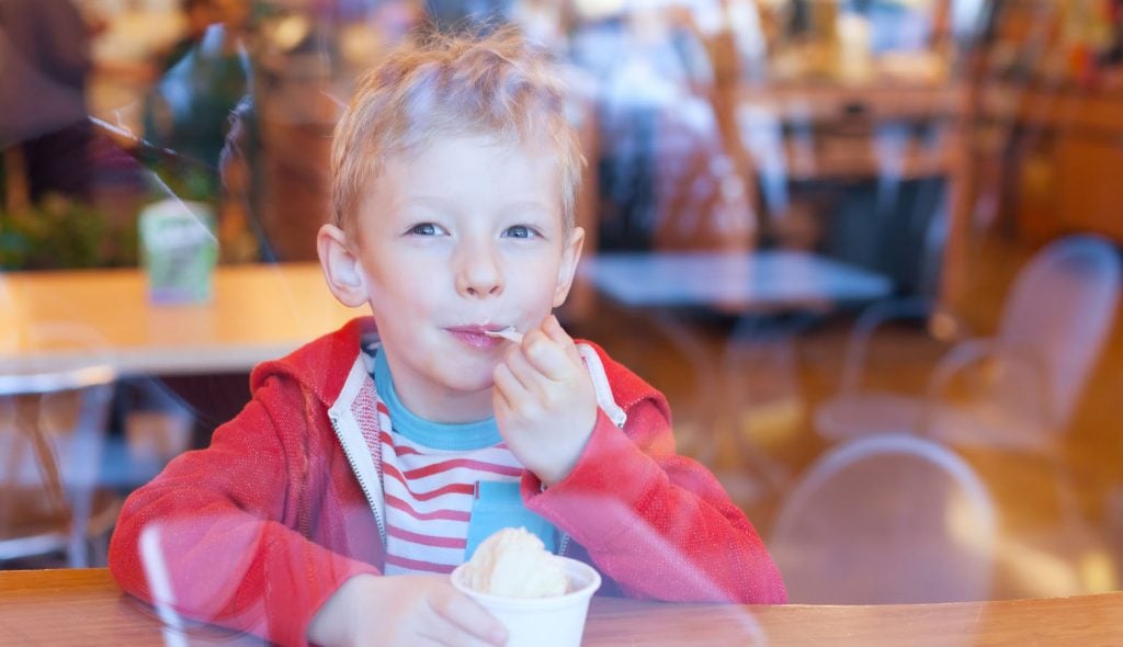 Stock image of little boy eating ice cream