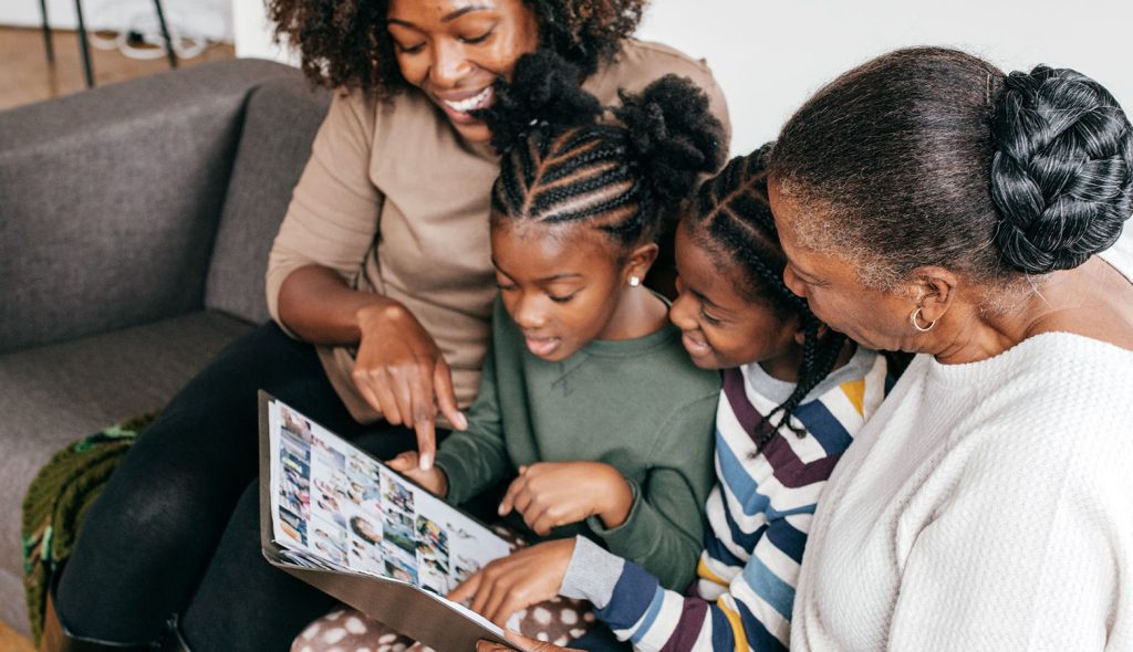 Image of kids/family looking at photo album