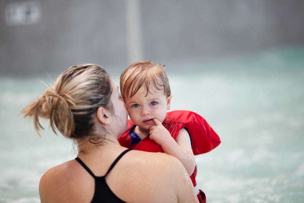 mom swimming with her toddler