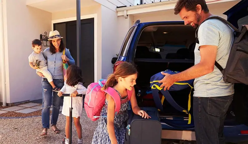 Family packing a car
