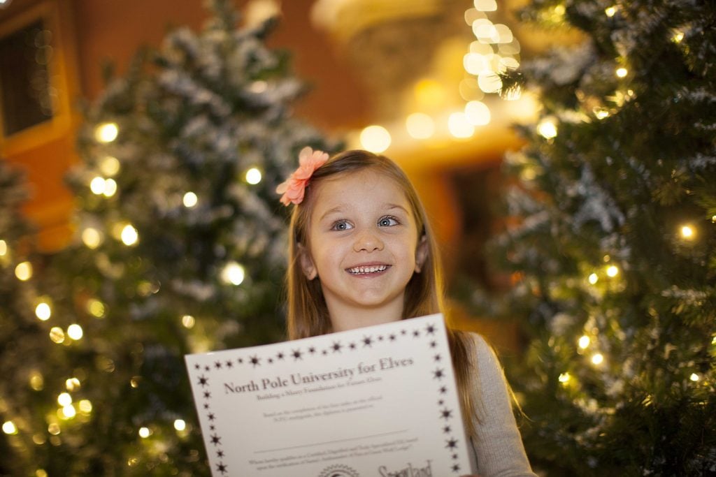 Little girl holding a snowploma.