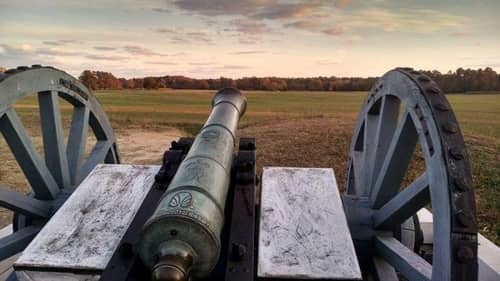A cannon overlooks an empty battlefield 