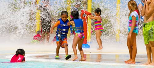 Little kids playing in the sprinklers at the Drytown Waterpark