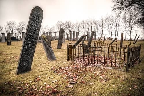 Old tombstones in a cemetery surrounded by leaves