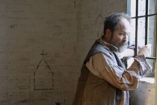 An actor playing the role of a patient at the Public Hospital Museum at Colonial Williamsburg