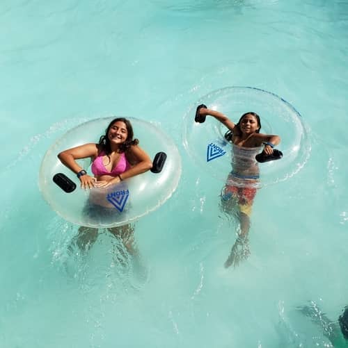 Two girls floating on tubes in the pool at Raging Waters