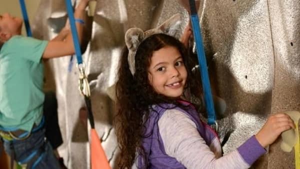 little girl climbing rock wall at Great Wolf Lodge