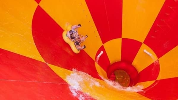 family on a raft riding a waterslide