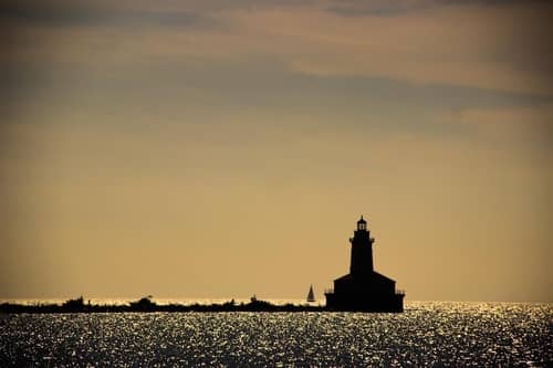 A sunset view of a lighthouse from the Chicago Water Taxi