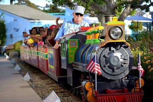 Little kids aboard a kiddie train at a theme park in Anaheim California