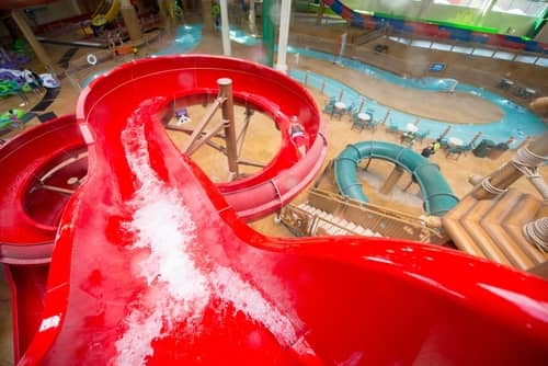 View of a towering red water slide at Great Wolf Lodge indoor water park