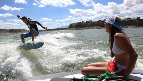 Alt Text: Couple wakesurfing at Lake Pueblo