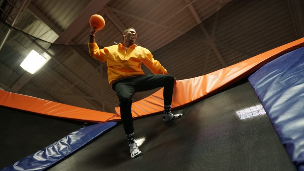 Teenager boy playing with basketball on trampoline in Anaheim California