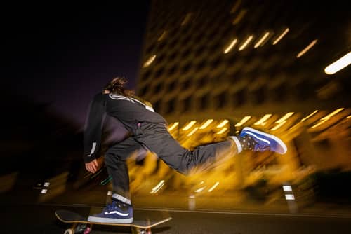Teenage boy riding skateboard with Vans shoes at Vans skatepark in Anaheim