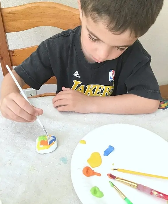 boy painting rocks