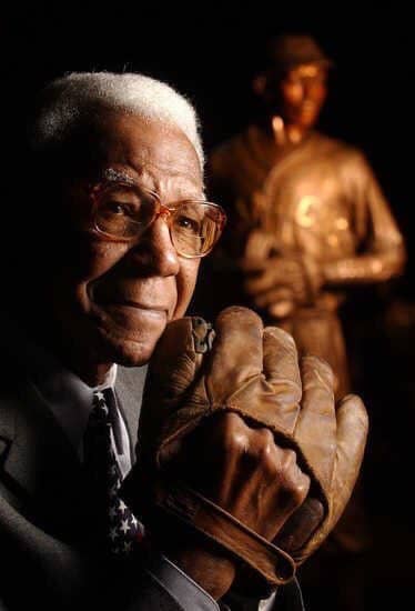 Jackie Robinson poses with his mitt at the Negro League Baseball Museum