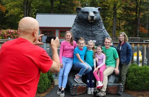 Visitors posing with a statue outside of Clarks Bears