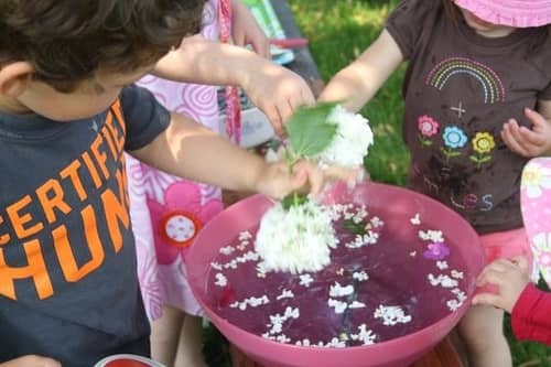 Kids making a soup from garden materials