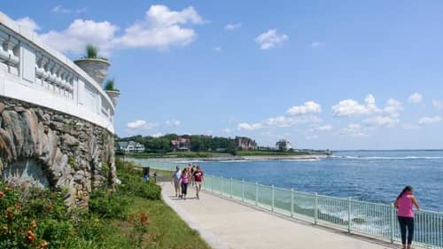Visitors enjoying the Newport Cliff Walk in Rhode Island