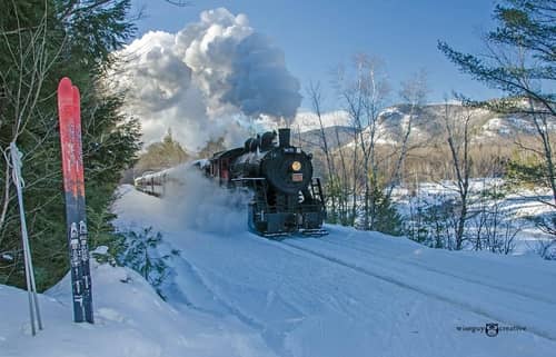 A vintage railroad running in the snow