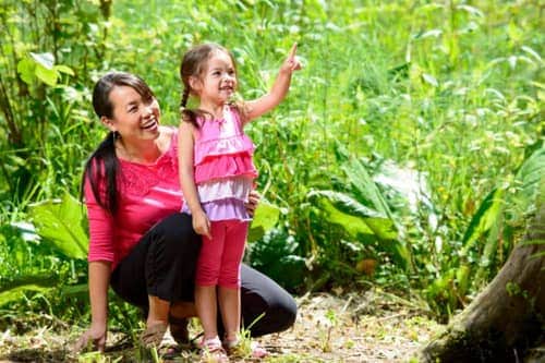 Mother and daughter playing a scavenger hunt in the yard