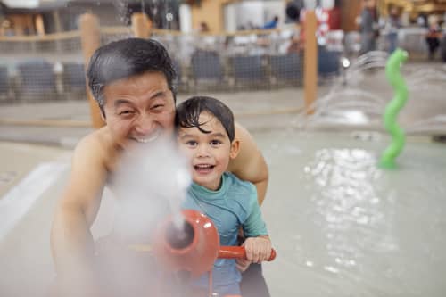 Father and son playing at the Great Wolf Lodge indoor water park in Concord, NC