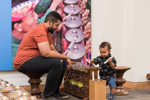 Father and son play at the Global Museum Instrument Museum