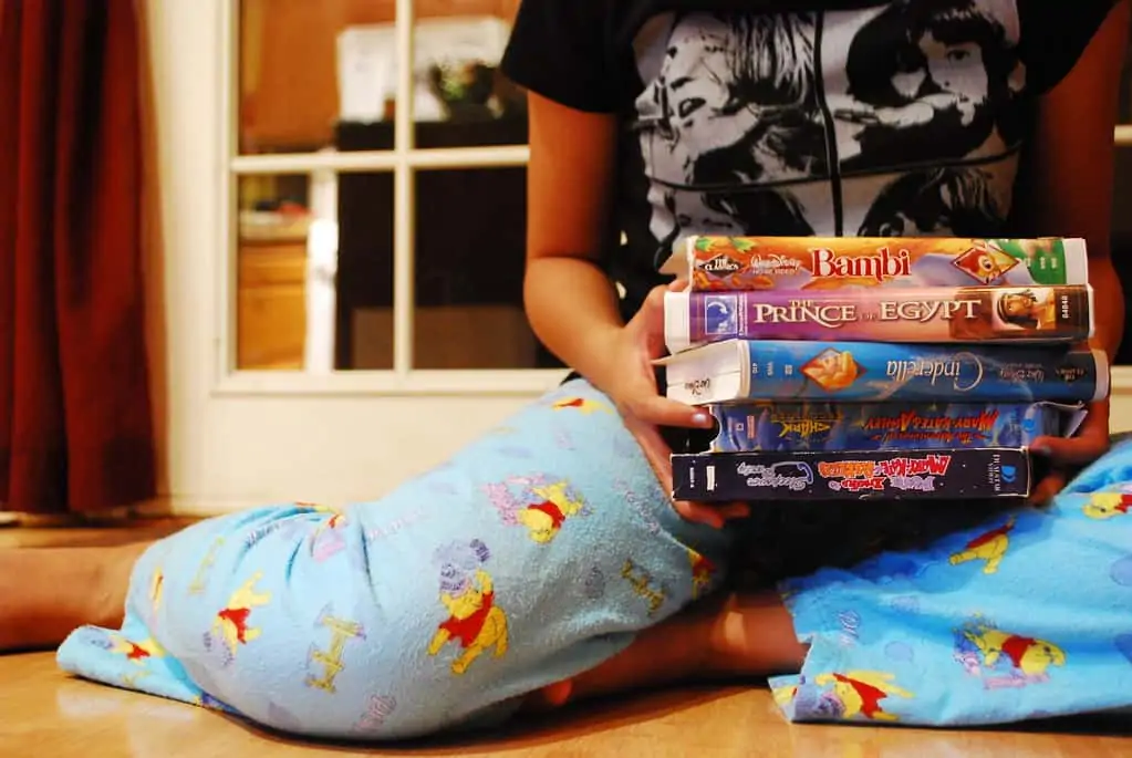 girl picking out a movie for the pajama party disney movie marathon