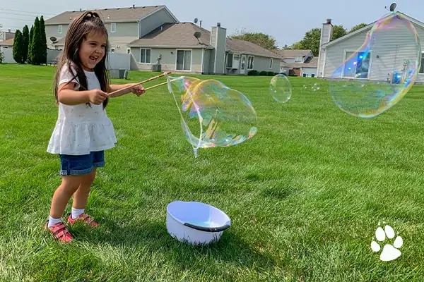 little girl creating massive bubbles