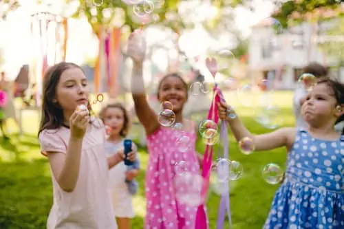 kids blowing bubbles at a party