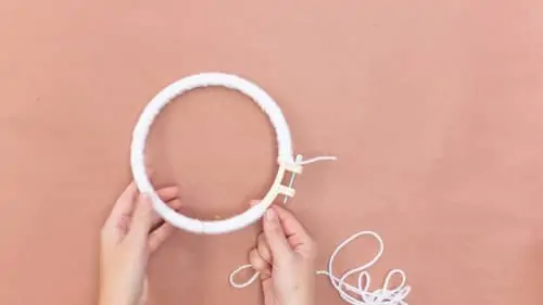 embroidery hoop covered in white yarn