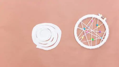 white felt in a circular spiral pattern next to DIY dream catcher
