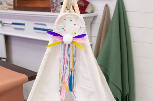 DIY dream catcher hanging on DIY teepee