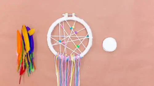 different colors of yarn and tied to bottom half of DIY dream catcher.