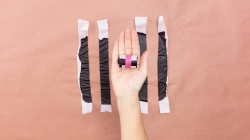 cutting parchment paper into strips to make DIY fruit snacks