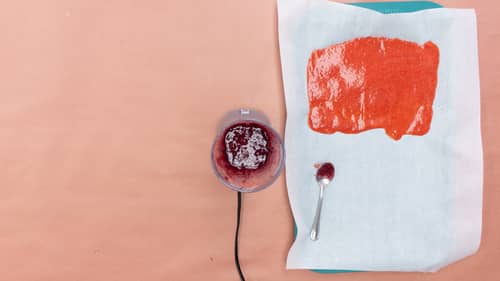 spread blended fruit mixture onto white parchment paper