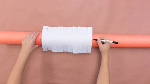 measuring white felt on top of orange pool noodle