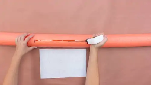 cutting a slit in orange pool noodle
