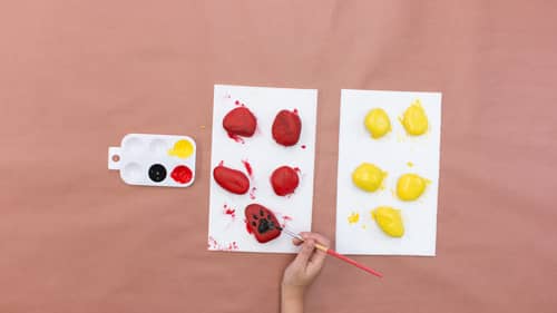 use black paint to create footprint on painted rocks