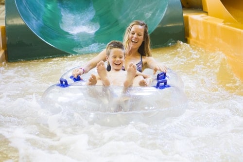 mother and child enjoying waterpark ride at great wolf lodge 