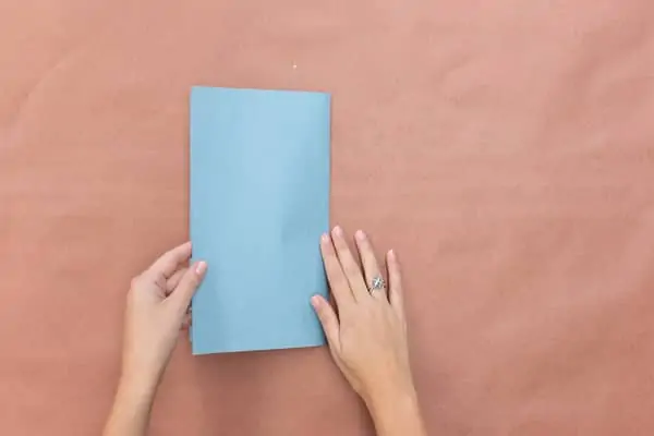 fold blue construction paper in half