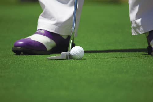 an adult putting at the riverside glof club chehalis