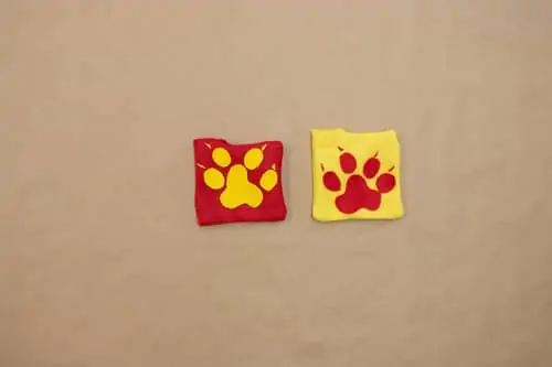 yellow paw print on red felt square, red paw print on yellow felt square