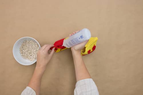 felt squares, bowl of beans and bottle of glue