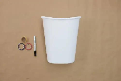 white bucket, black pen, three rolls of decorative tape