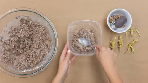 three bowls of mixture and dinosaur figurines 